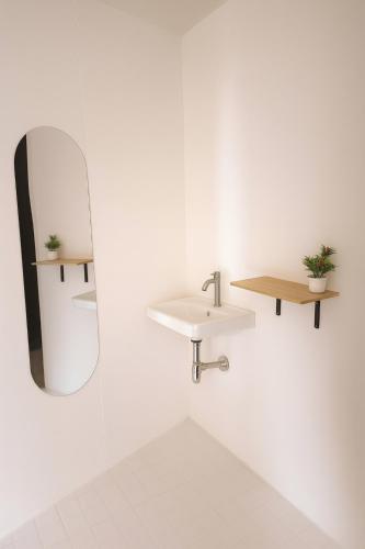 a bathroom with a mirror and a sink at Baan AoKao KohMak in Ko Mak