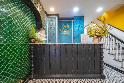 a staircase with a black gate and a green wall at Belvilla Near Tan Son Nhat International Airport - Formerly Vyvy Hotel in Ho Chi Minh City
