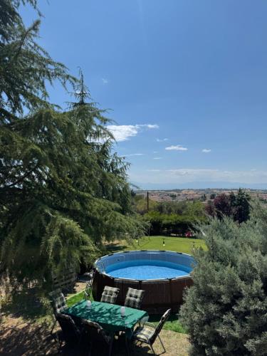 a pool in a yard with a table and chairs at E L urban villa. in Epanomi