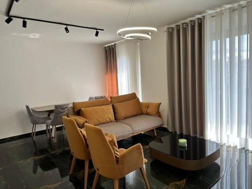 a living room with a couch and a table at DeSa Radhime in Radhimë