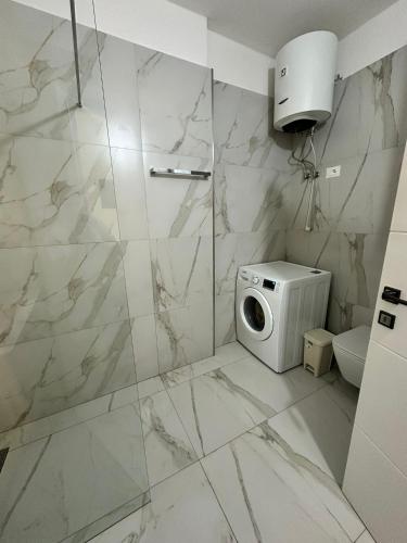 a bathroom with a toilet and a microwave at DeSa Radhime in Radhimë
