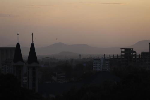 a view of a city with mountains in the background at Tai Africa Guest Rooms in Arusha