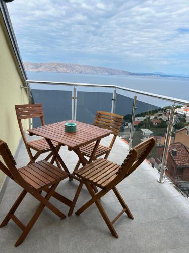a wooden table and two chairs sitting on a balcony at Villa Panorama in Senj