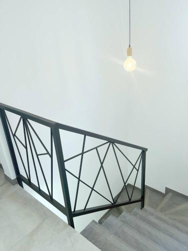 a staircase with a glass railing and a light at Villa Paradisiaque au cœur de Grand Baie in Mauritius