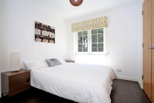 a bedroom with a white bed and a window at Luxury 2 bedroom apartment in Aberdeen in Kirkton of Skene
