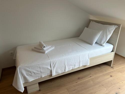 a white bed with a phone on top of it at Villa Panorama in Senj
