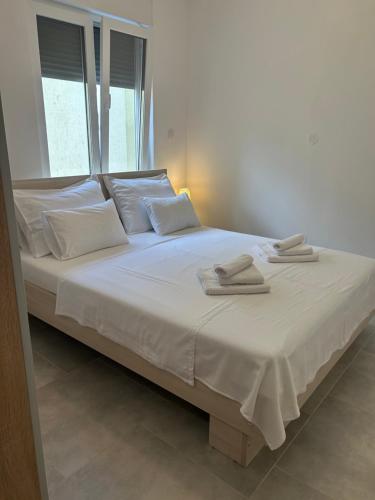 a white bed with two towels on top of it at Villa Panorama in Senj