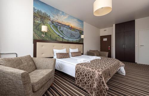 a hotel room with a bed and a couch at Vilnius City Hotel in Vilnius