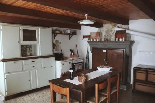 a kitchen with a wooden table and a stove at Casa l'Acerone in Pian degli Ontani