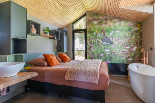 a bedroom with a large bed and a bath tub at Tinyhouse 32 Stavoren in Stavoren