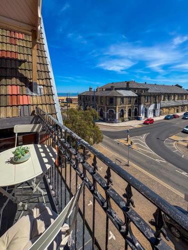 a balcony with a table and a view of a street at Euston Road - Beach Apartment 4 in Great Yarmouth