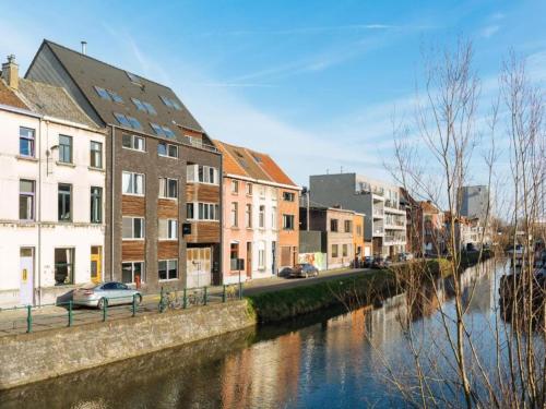 a river in a city with houses and buildings at Apartment in Maldegem with Scenic Terrace in Maldegem