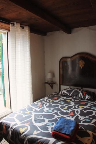a bedroom with a large bed with a large window at Casa l'Acerone in Pian degli Ontani