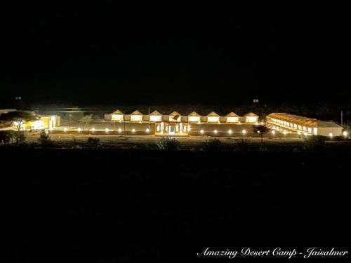 a large building lit up at night with lights at Amazing Desert Camp in Jaisalmer