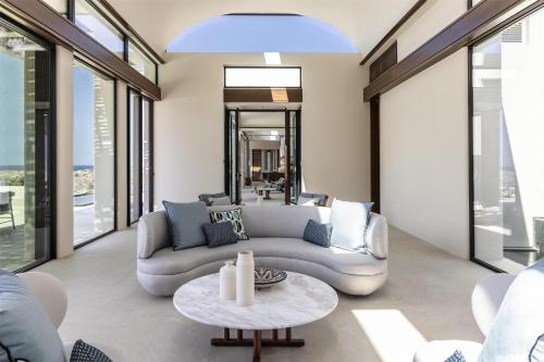 a living room with a couch and a table at One&Only Kéa Island in Pisses