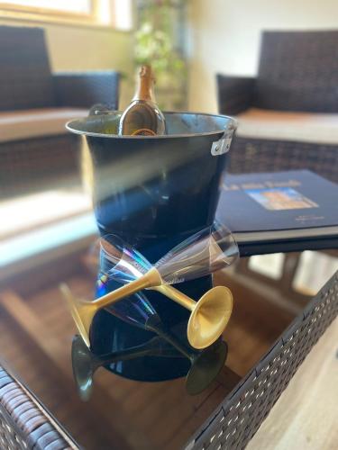 a glass container with a bottle and spoons on a table at Il Campanile in Fondi