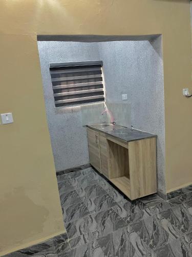an empty room with a desk and a window at STJ Luxury Hotels in Ilorin