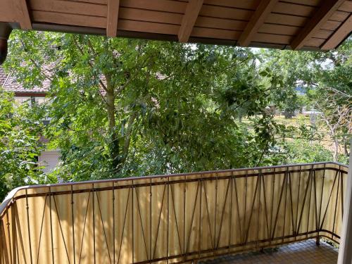 a wooden balcony with a tree in the background at Holunder in Dinkelsbühl