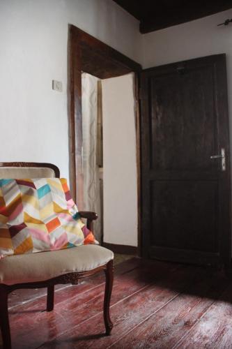 an empty room with a chair and a door at Casa l'Acerone in Pian degli Ontani