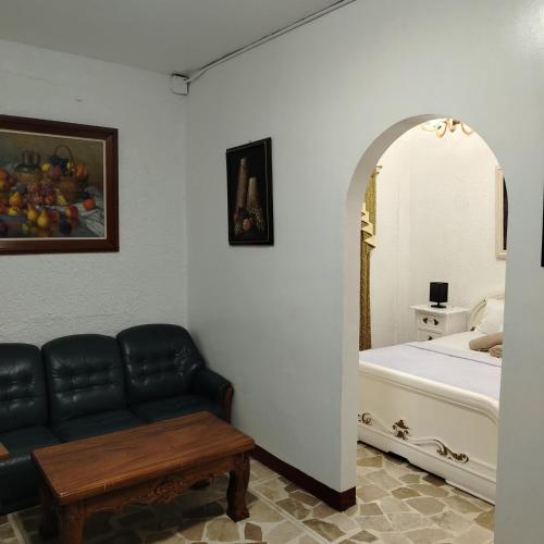 a living room with a couch and a bed at White & Yellow Castle Hotel and Resort in Calatagan