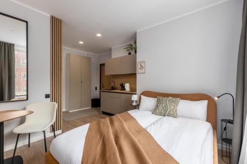 a bedroom with a bed and a table and a kitchen at P6-A Riga Old Town Apartments in Rīga