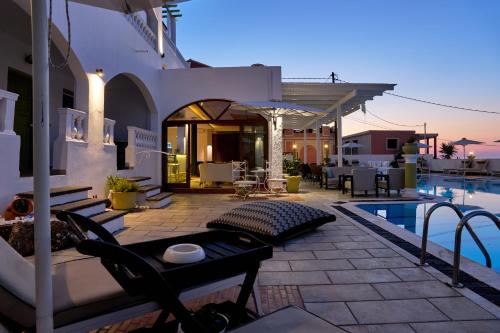 a villa with a swimming pool at night at Fedra Mare in Agios Stefanos