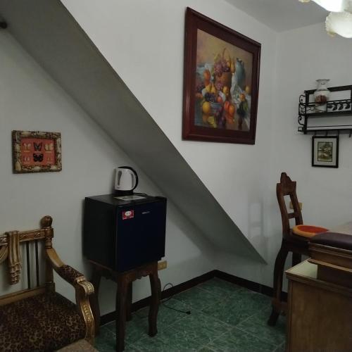 a room with a staircase with a telephone and a chair at White & Yellow Castle Hotel and Resort in Calatagan