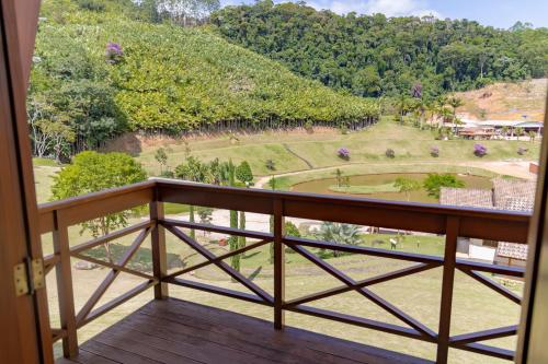 a balcony with a view of a park at Pousada Bela Aurora in Venda Nova do Imigrante