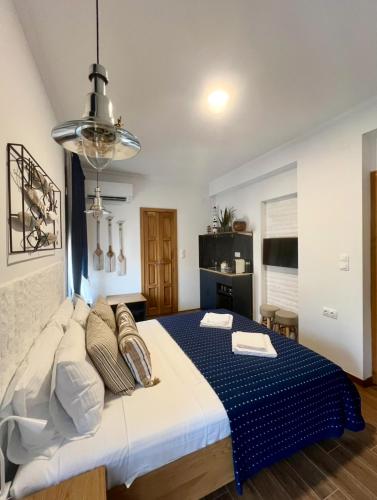 a bedroom with a large bed in a room at Avra Guesthouse in Limenas