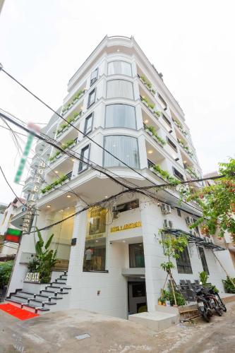 a tall white building with stairs in front of it at Belvilla Near Tan Son Nhat International Airport - Formerly Havana Hotel in Ho Chi Minh City