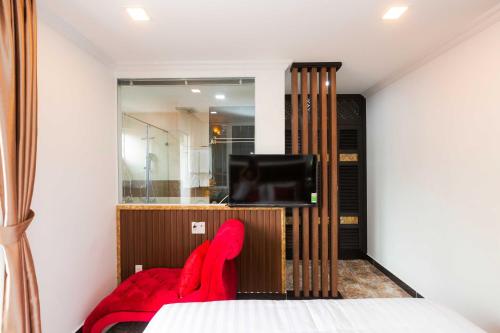 a bedroom with a bed and a tv in it at Belvilla Near Tan Son Nhat International Airport - Formerly Havana Hotel in Ho Chi Minh City
