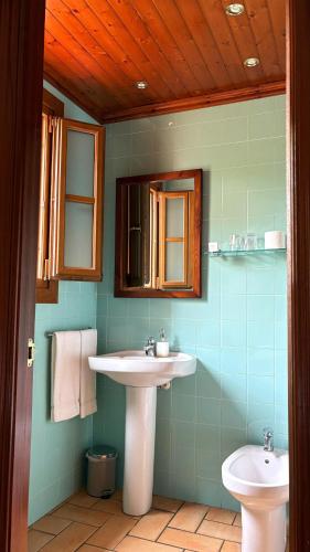 a bathroom with a sink and a toilet at Hotel Antiga in Calafell