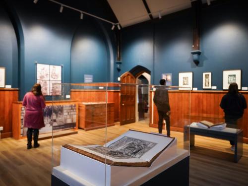 a museum with people standing around a display case at Ushaw Historic House, Chapels & Gardens in Durham