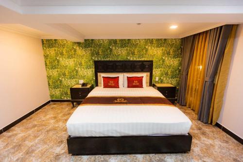 a bedroom with a large bed in a room at Belvilla Near Tan Son Nhat International Airport - Formerly Havana Hotel in Ho Chi Minh City