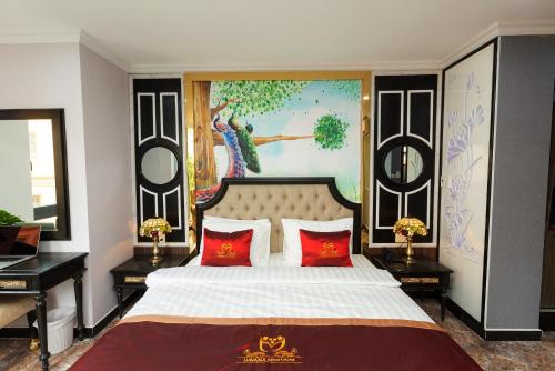 a bedroom with a bed with a painting on the wall at Belvilla Near Tan Son Nhat International Airport - Formerly Havana Hotel in Ho Chi Minh City
