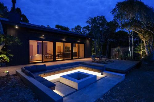 a backyard with a couch and a fire pit at night at UMIBE Terrace in Shima