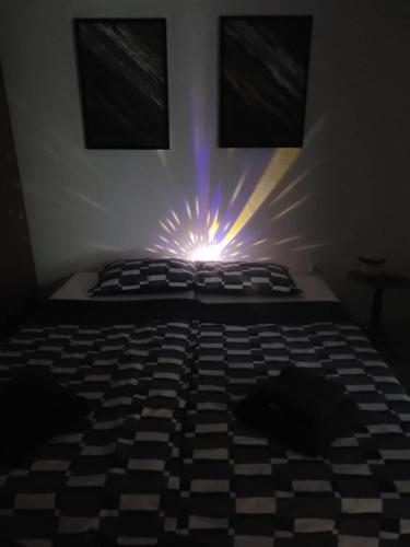 a bedroom with a bed with a light on it at Hiža Guesthouse in Sarajevo