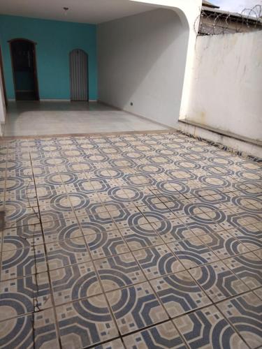a room with a tiled floor in a building at Hospedagem Sousa Santos in Montes Claros