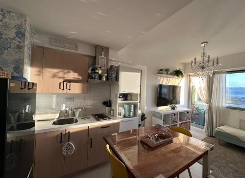 a kitchen with a table and a dining room at Condo in Batasan Hills with a Mountain view in Manila