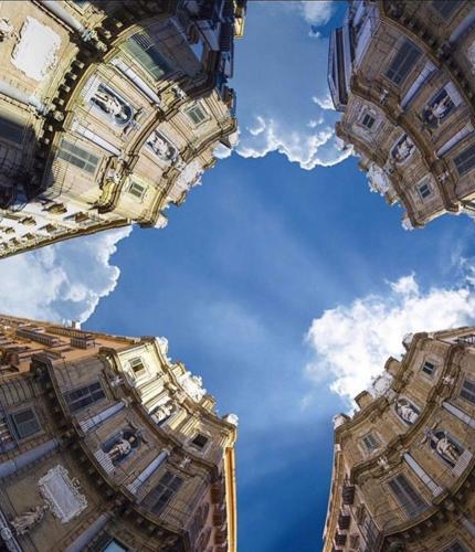 two tall buildings looking up into the sky at Borbon Home luxury rooms & SPA in Palermo
