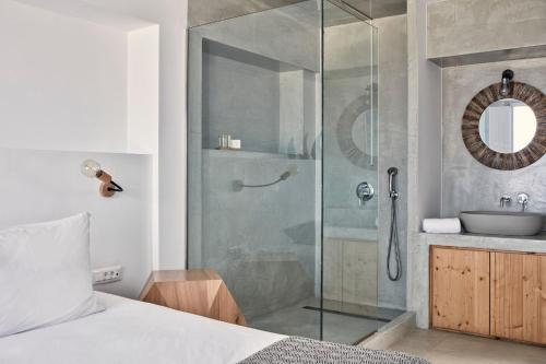 a bathroom with a glass shower and a sink at Luxury Santorini Villa Villa Elysian Pente Private Pool 2 Bedrooms in Foinikiá