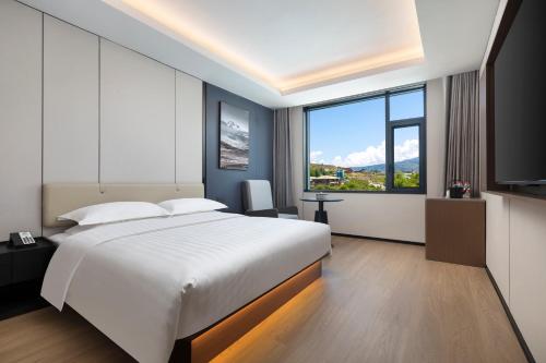 Ένα ή περισσότερα κρεβάτια σε δωμάτιο στο Days Inn by Wyndham Songpan Chuanzhu Temple