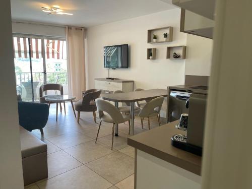 a kitchen and dining room with a table and chairs at Hotel Le Fouquet's in Cannes