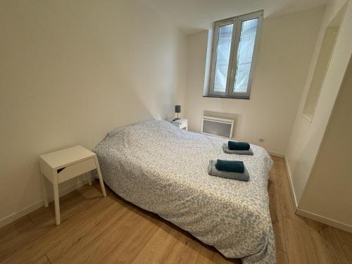 a small bedroom with a bed and a window at Charmant appartement Gramat in Gramat