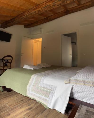 a bedroom with two beds and a wooden floor at Casa dei Colli in Monzambano