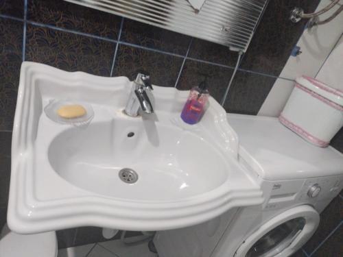 a white sink and a toilet in a bathroom at Hiža Guesthouse in Sarajevo