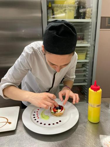 a man is eating a dessert on a plate at B&B l'Angolo di Rosina con ristorante in Novello