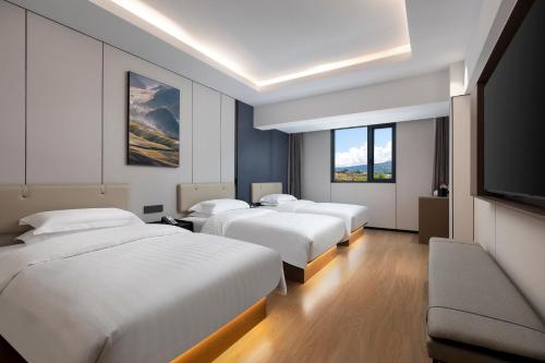 Ένα ή περισσότερα κρεβάτια σε δωμάτιο στο Days Inn by Wyndham Songpan Chuanzhu Temple