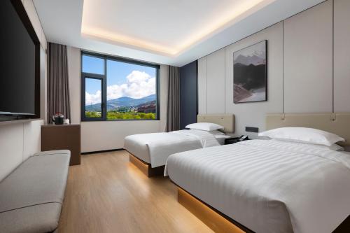 Ένα ή περισσότερα κρεβάτια σε δωμάτιο στο Days Inn by Wyndham Songpan Chuanzhu Temple