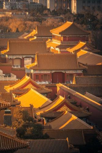 an overhead view of a building with yellow roofs at East Sacred Hotel-Very close to the Drum Tower,The Lama Temple,Houhai Bar Street,Nanluoguxiang,Tiananmen Square and the Forbidden City, and the subway st ation is also very close in Beijing